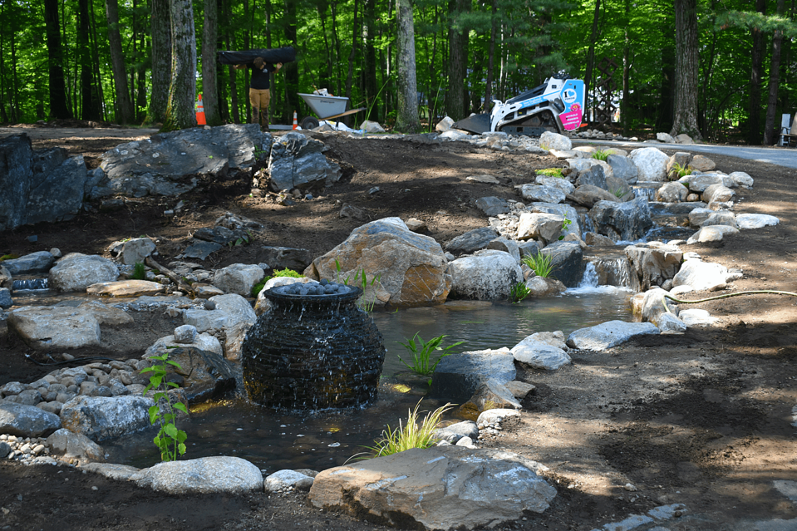 Backyard pond with stones and small waterfall